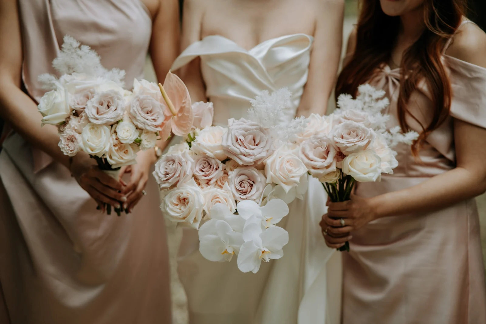 Bridal party holding blush and ivory bouquets by Willow & Peony, Auckland