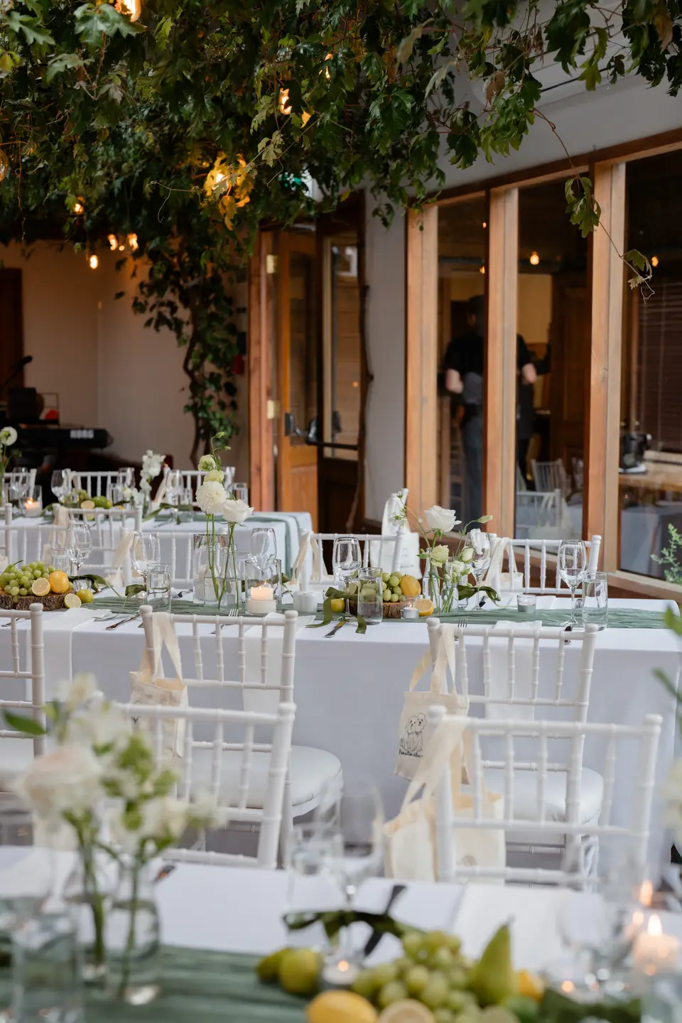 Reception tables with bud vases and fruit at Markovina Vineyard Estate